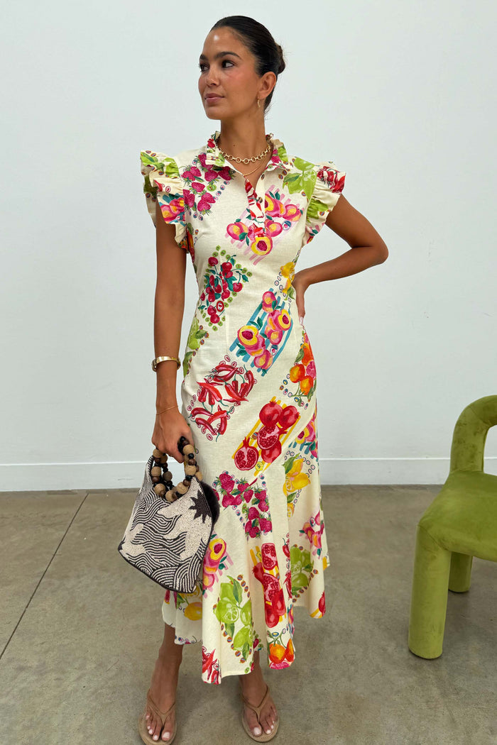 Fruit Stamps Remi midi dress in white cotton-linen with ruffle sleeves, a buttoned collar and colourful fruit motifs.