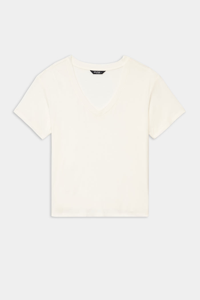 The Georgia Jersey V-Neck - White by SPLITS59, a soft blend short-sleeve crop top, is shown laid flat on a white background.