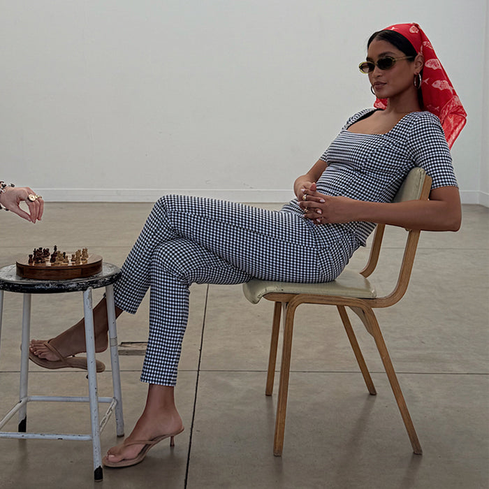 Black and white Gingham Trousers and matching top co-ord with a skinny leg, styled with a red headscarf and tan heels.