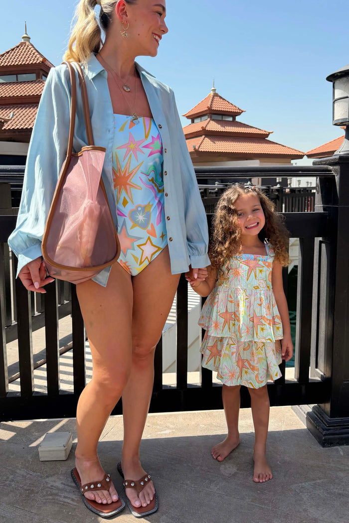 Girl's Starburst Skirt Co-ord Set in blue cotton with a sun and star print and tiered skirt on a young girl.