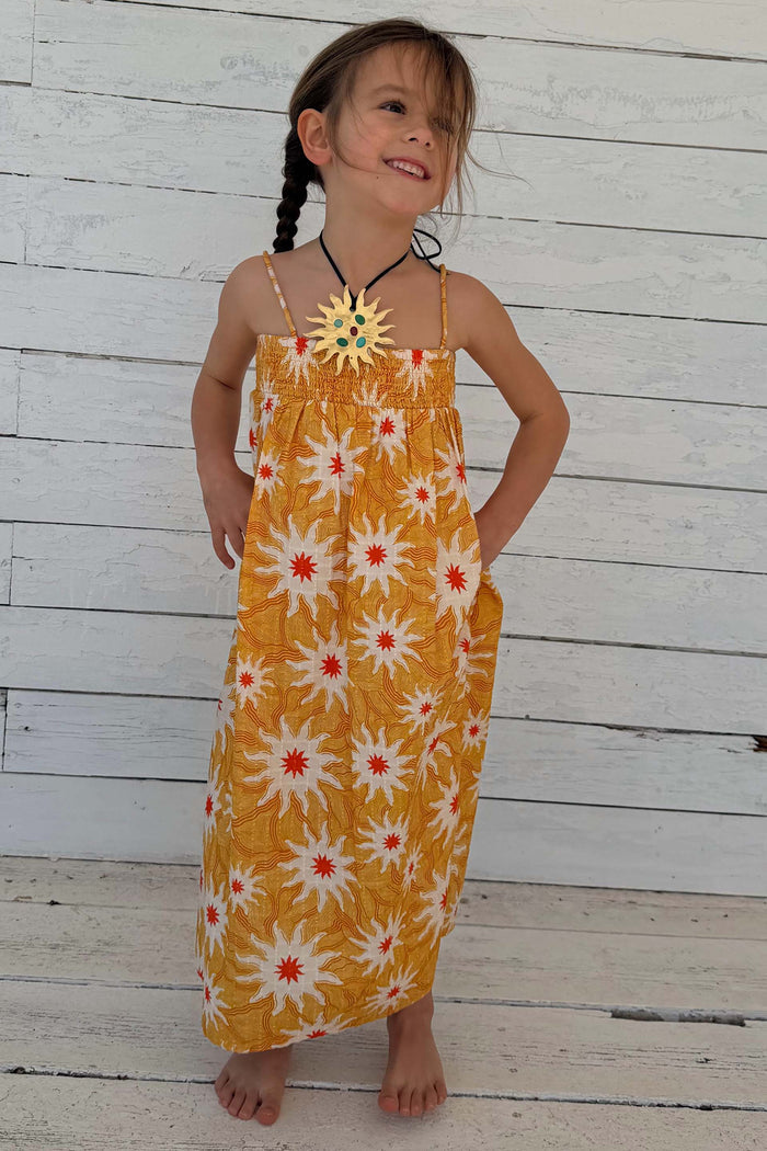 NFD Kids Yellow Cotton Sun Dress featuring a sunburst print, shirred top and floaty maxi skirt.
