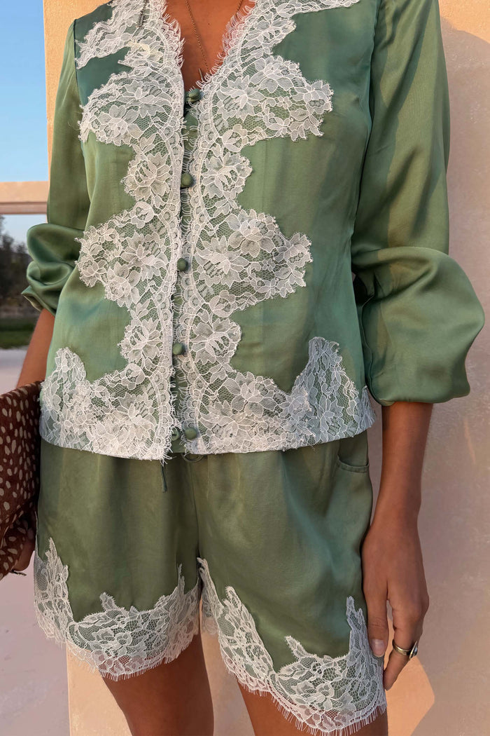 Green Lace Maeva Shorts and matching satin shirt with intricate white lace trim and button details.
