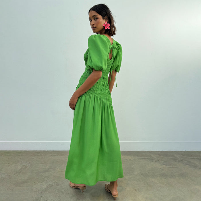 Green Shirred Nara Dress featuring puffed sleeves and a tie neck fastening, shown from a rear-side view.