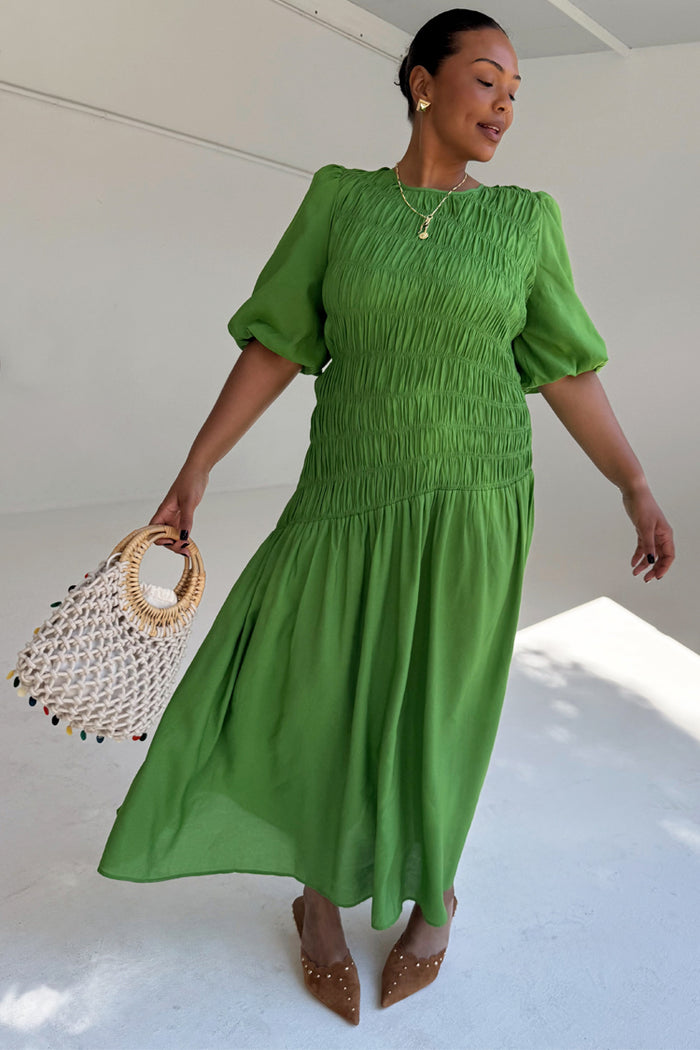 Green Shirred Nara Dress with a shirred bodice and puff sleeves, highlighting inclusive sizing.