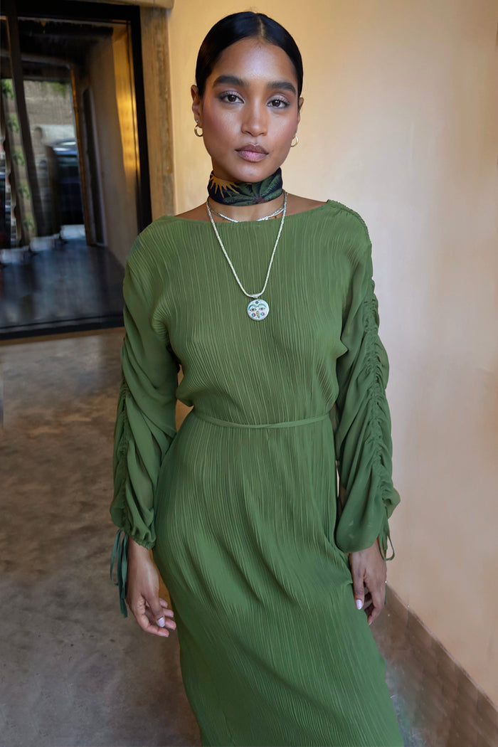 Khaki Celia Plisse Dress with long ruched sleeves and a textured pleated finish in a deep green tone.