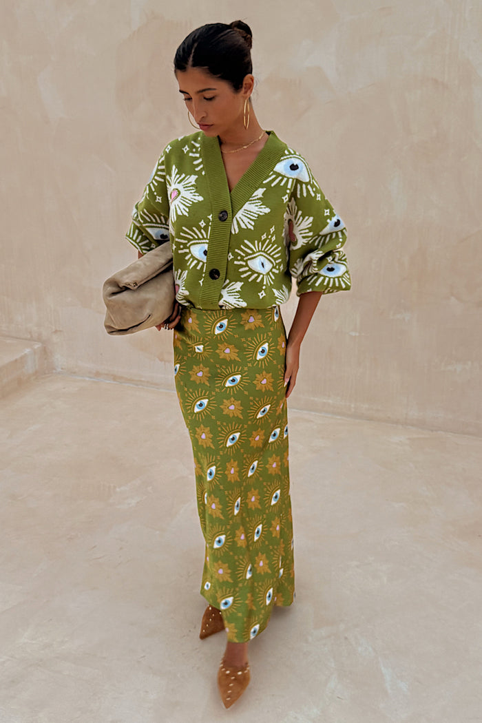 Khaki Eye Dorris Skirt with a green heart and eye print, styled with a matching cardigan for a coordinated London look.