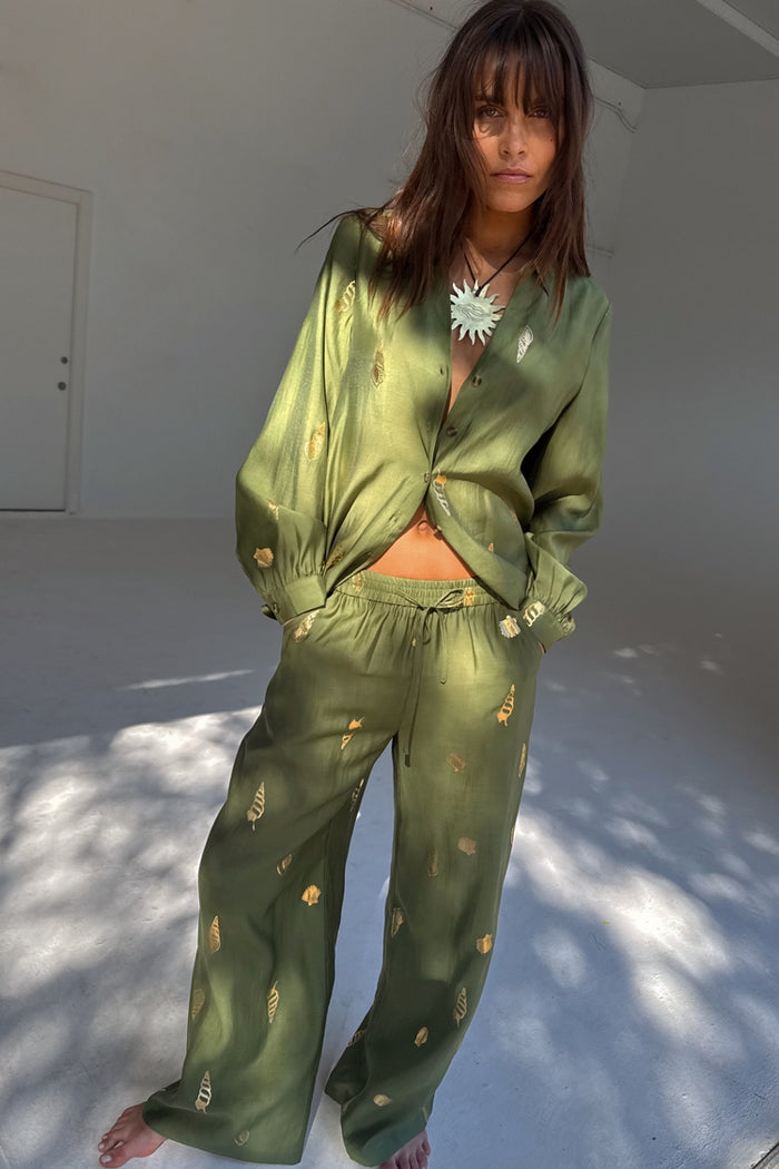 Khaki Shell Trousers with a gold shell print, wide-leg fit and elasticated waist, styled as a co-ord set.