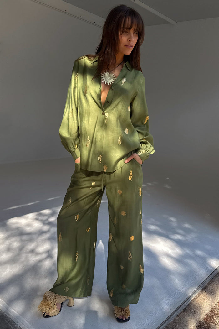 Khaki Shell Trousers featuring a gold shell print and wide-leg fit, styled as a co-ord set with a matching shirt.