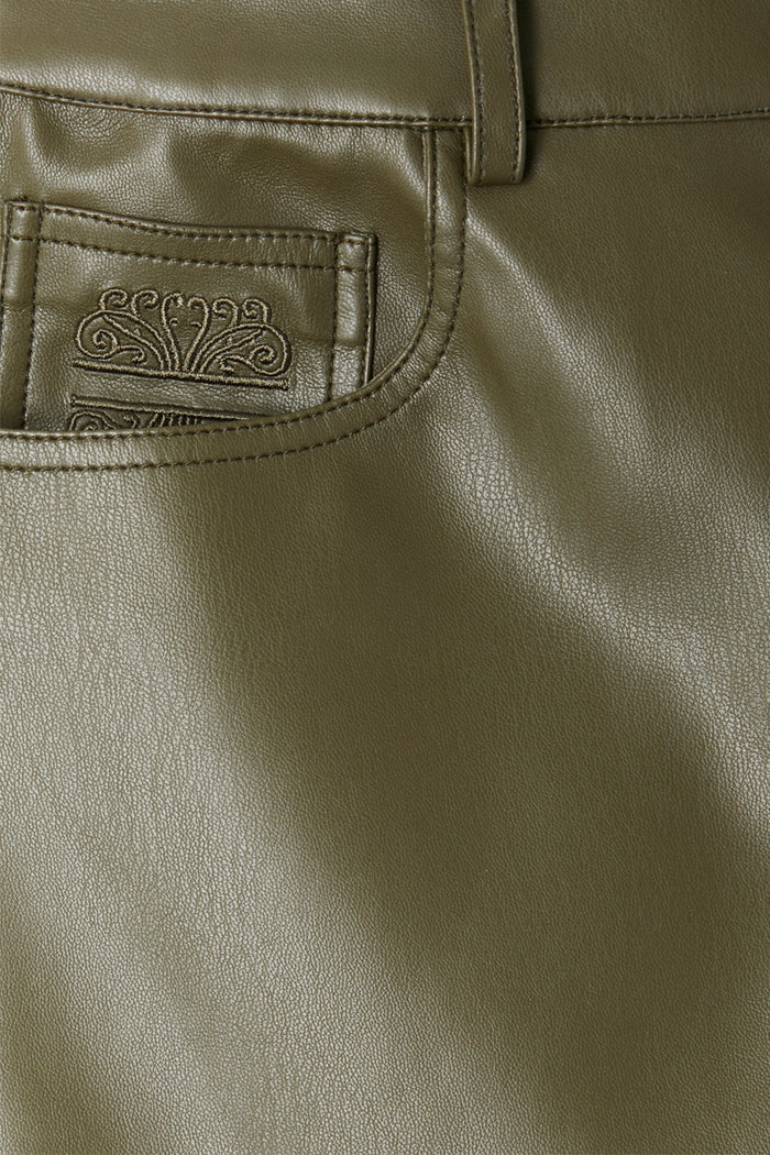 Khaki vegan leather trousers featuring a detailed view of the front pocket and signature embroidered logo.