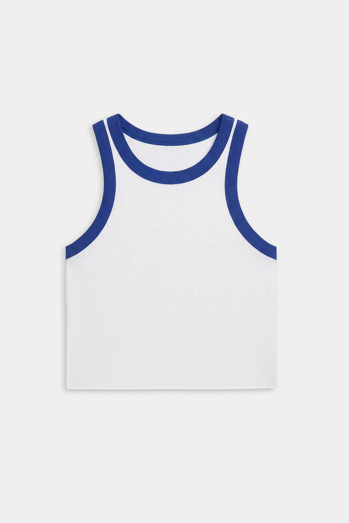 The SPLITS59 Kiki Rib Crop Tank in White/Cobalt is a sleeveless, white cropped top with cobalt ribbed trim at the neckline and armholes, made from soft baby rib fabric and shown flat on a white background.