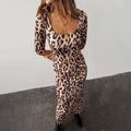 Leopard Iris Dress with a scoop neckline and ruching detail at the waist, styled with a chunky gold necklace.