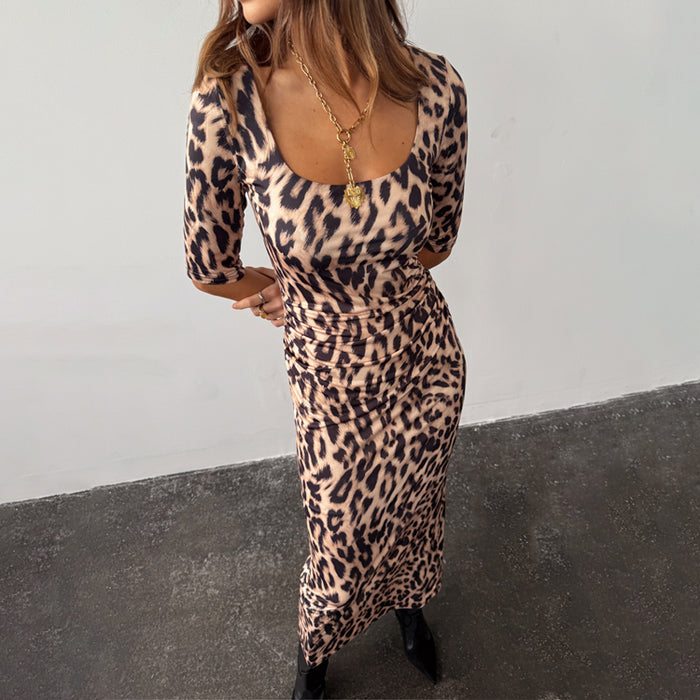 Leopard Iris Dress with a scoop neckline and ruching detail at the waist, styled with a chunky gold necklace.