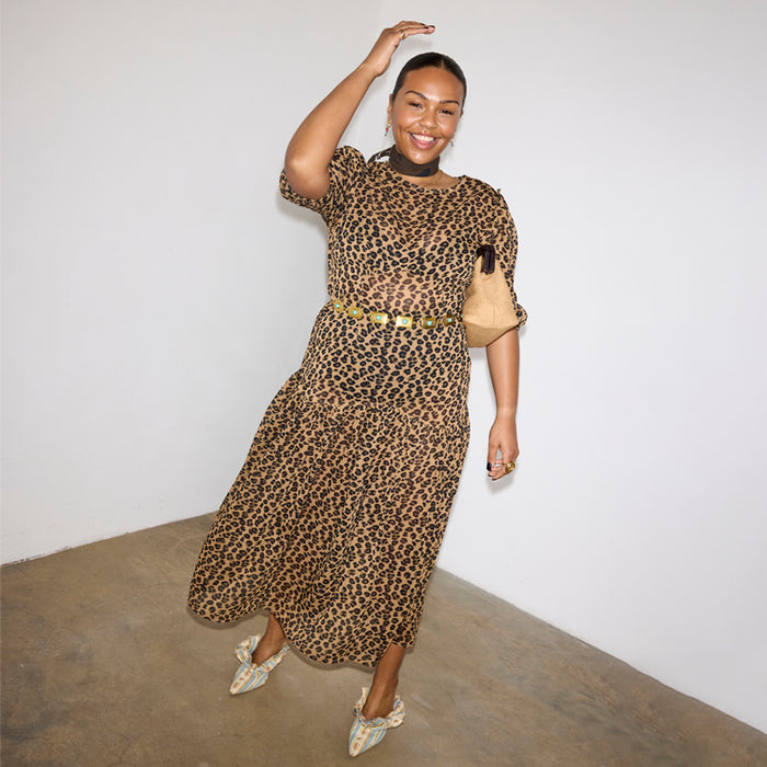 Iconic Leopard Lucia sheer dress with puff sleeves and a tiered skirt, styled with a gold belt.