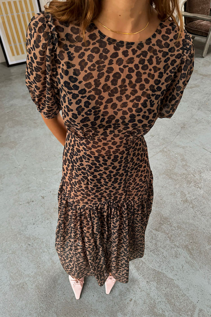 Sheer Leopard Lucia Dress featuring puff sleeves and a tiered skirt in an iconic leopard print.