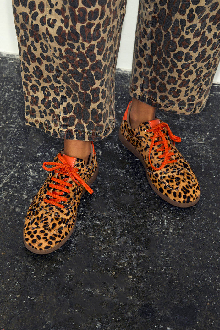 Leopard Pony Trainer in premium leather with leopard print, orange laces and matching trousers.