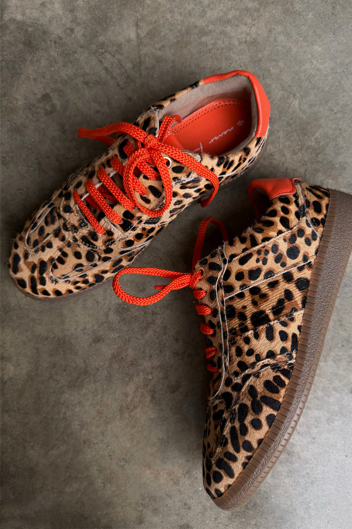 Leopard Pony Trainer featuring a textured leopard print leather upper, contrast orange laces and a gum sole.