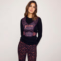 Iconic Leopard Running Bag in dark purple print with coral zips, styled with matching print leggings.