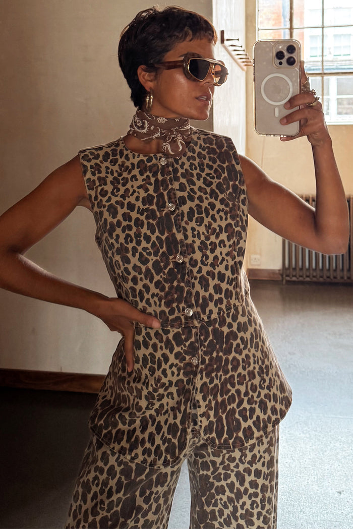 Iconic leopard print waistcoat with engraved metal buttons, styled with matching trousers for a London look.