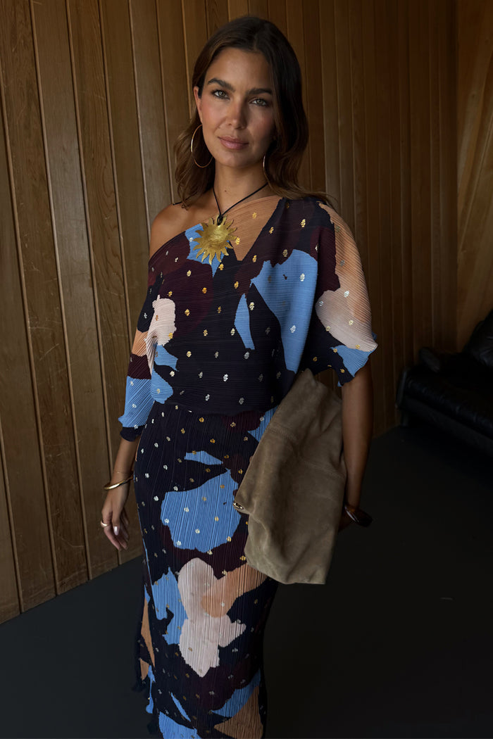 Mara Abstract Tilly Dress in brown plisse with gold metallic flecks, styled as a one-shoulder midaxi.