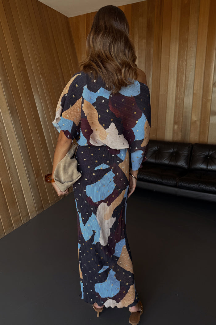 Mara Abstract Tilly Dress with a plissé finish, featuring a blue and brown abstract print and gold flecks.