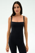 A woman faces forward in the SPLITS59 Monah Rigor Tank - Black and black leggings, set against a plain light background.