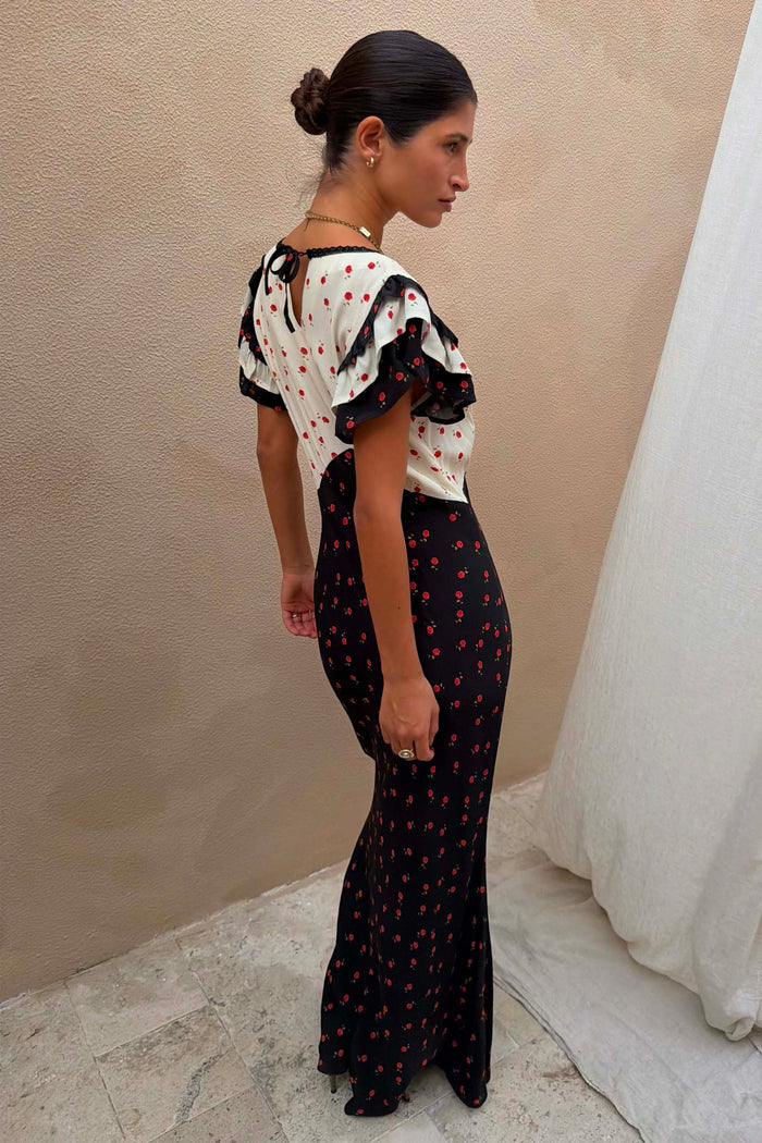 Mono Rose Betsy Midi Dress with monochrome floral panels, red roses and frill sleeves, styled on a model.