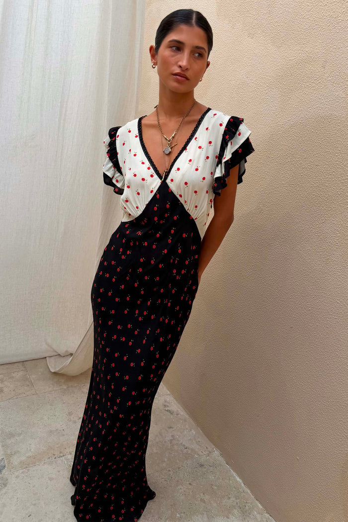 Mono Rose Betsy Midi Dress with contrast black and white panels, red rose print and frill sleeves on a model.