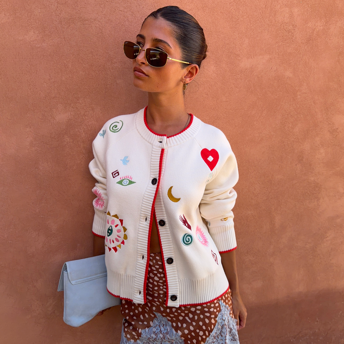 Morocco Charms Cheryl Cardigan in cream with red trim and colourful embroidered motifs, styled on a model.