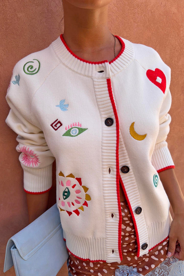 Cream Morocco Charms Cheryl Cardigan with red trim, featuring iconic colourful motifs on a soft-touch knit base.