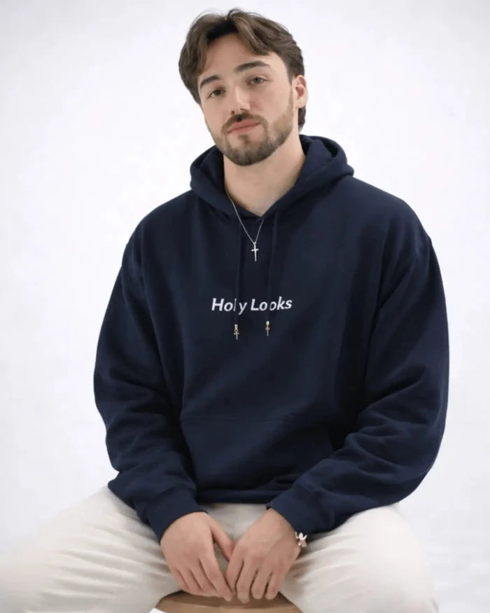 Man wearing a navy blue hoodie with 'Holy Looks' text on a white background