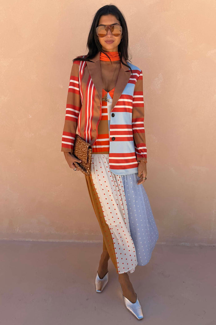 Multi Stripe Bea Dress in orange and blue with a pleated polka dot skirt, styled with a striped blazer and scarf.