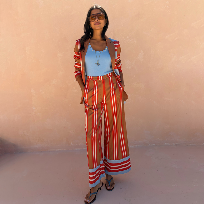 Multi Stripe Marnie Trousers in a bold red and blue stripe print, featuring a wide-leg silhouette designed in London.