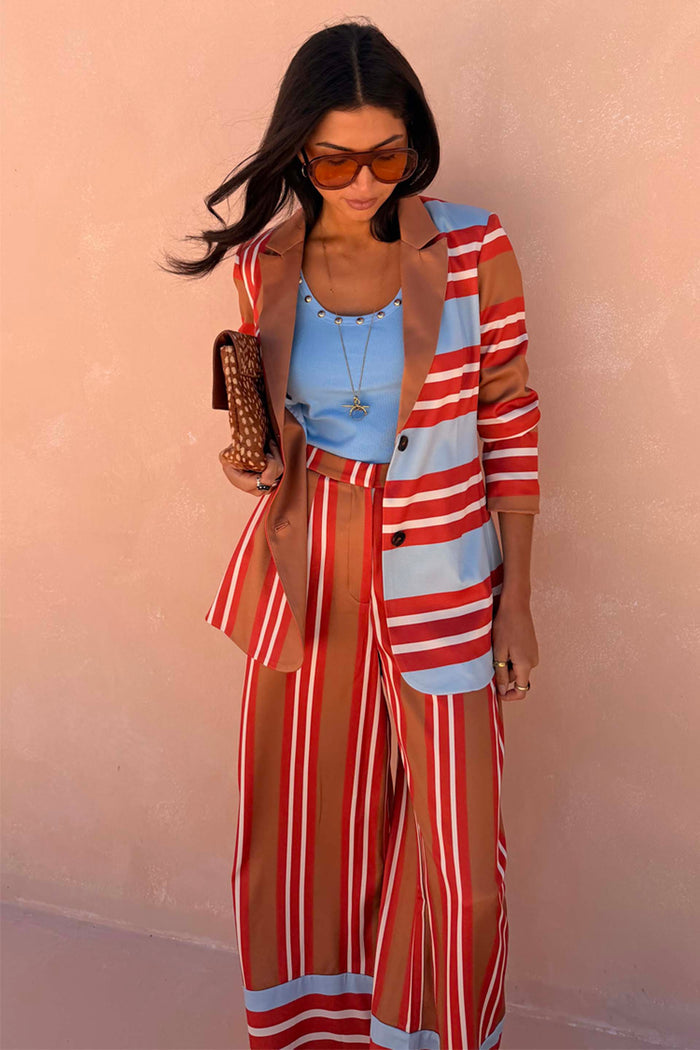 Multi Stripe Marnie Trousers in bold blue, red and brown stripes with a wide-leg fit and satin-esque finish.