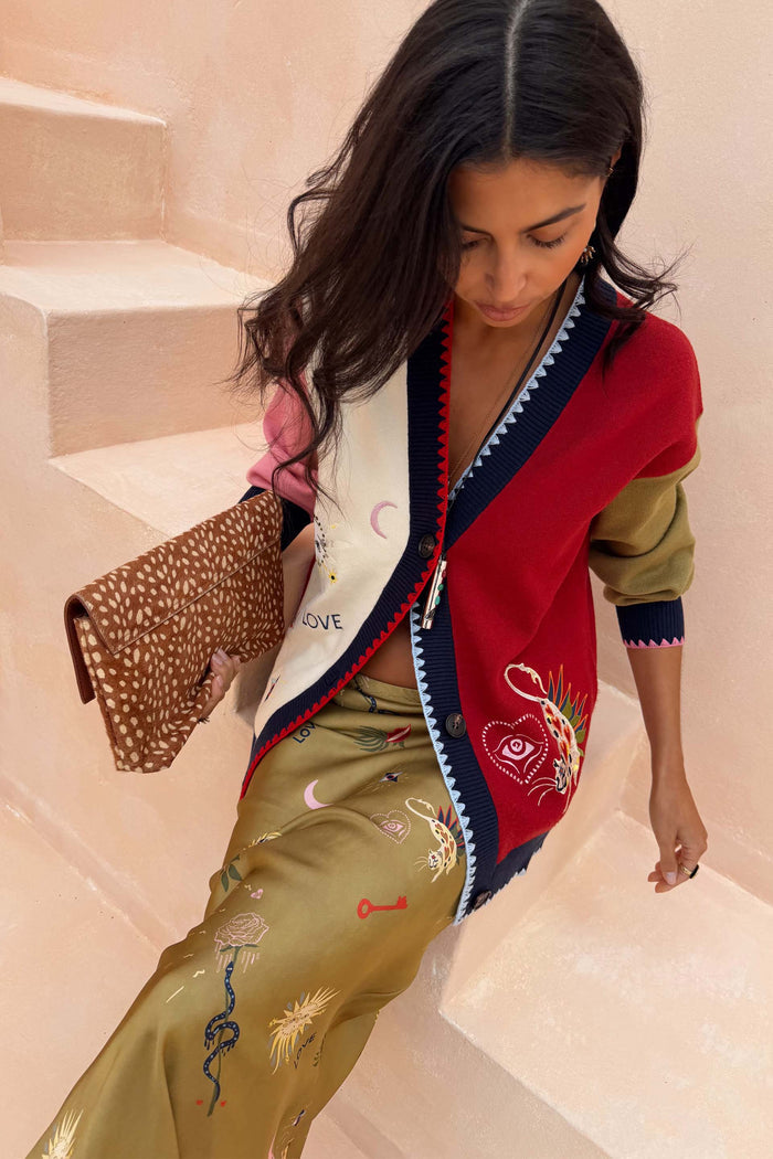 Mystical Martha Cardigan in a multicoloured knit with embroidered motifs and contrast blanket stitching.