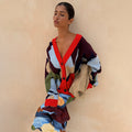 Navy Abstract Callie Cardigan featuring a bold artist print and red ribbed trims, styled with a matching skirt.