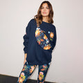 Navy Charm Bumbag with hand-painted sun motifs, worn crossbody over a matching navy sweatshirt and leggings.