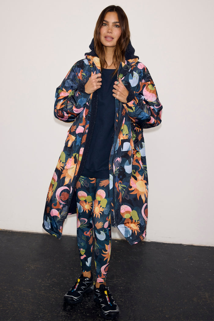 Navy Charm Coat with a colourful celestial print, featuring a cosy borg lining and waterproof fabric.