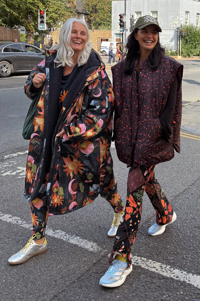 Navy Charm Coat with hand-painted celestial motifs and borg lining, styled as a London look on two women.