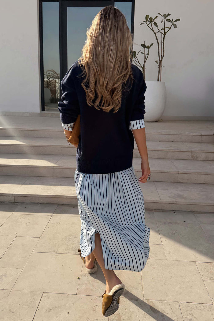 Navy Knit Jumper Dress with a striped cotton skirt, shown from behind to highlight the casual-chic, layered design.