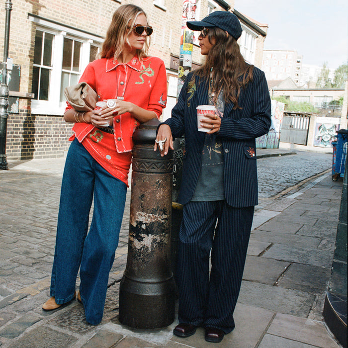 Navy Pinstripe Arden Trousers and matching blazer styled on a London street for an iconic smart casual look.