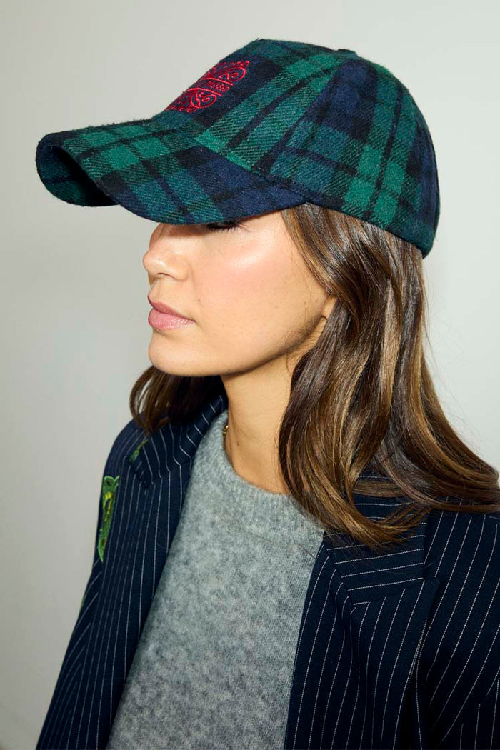 Navy Tartan NFD Cap featuring blue and green checks and a red embroidered logo, styled with a pinstriped blazer.
