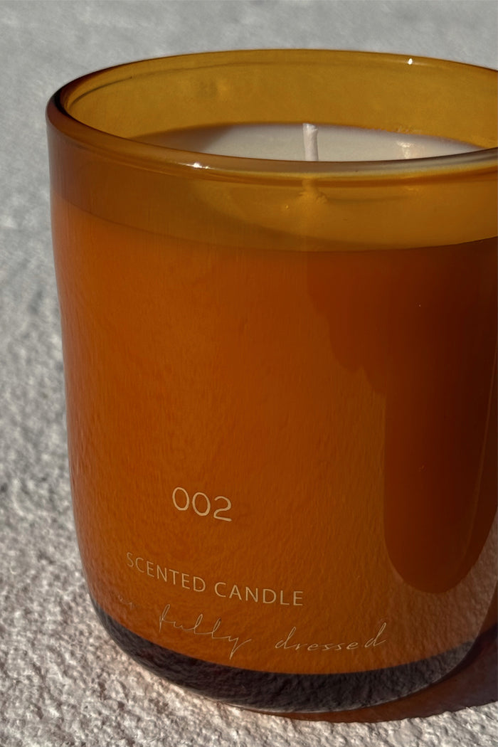 NFD Eau De Parfum Candle 002 in a mandarin-toned glass jar with signature branding.