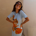 70s-inspired Orange Acetate Visor Sunglasses with tinted lenses, styled with a blue floral t-shirt dress.