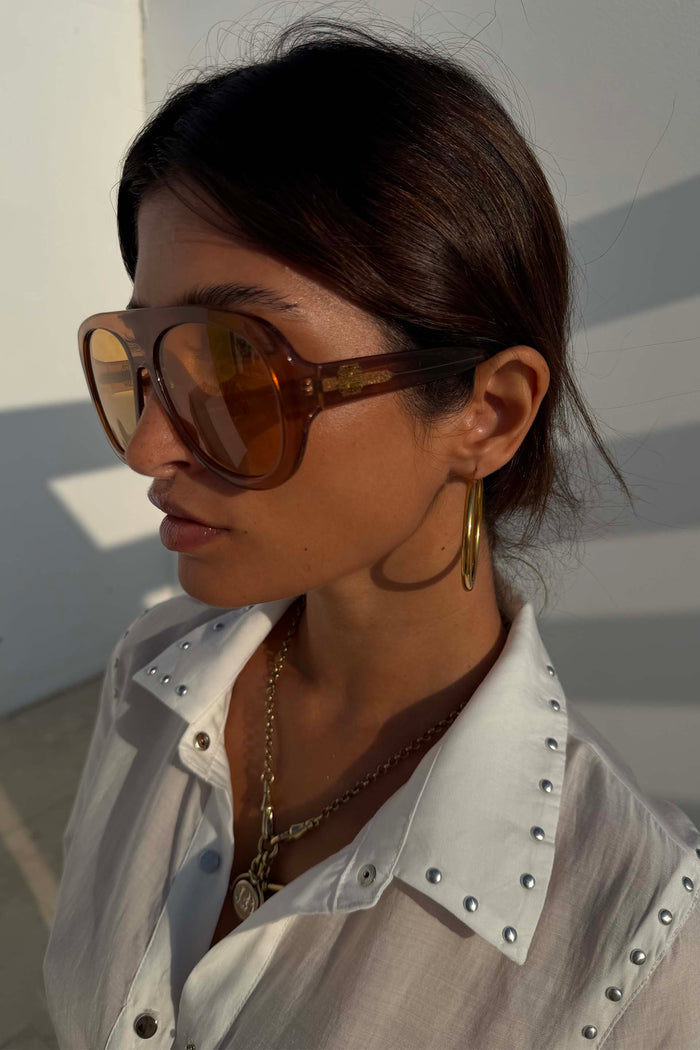 70s-inspired Orange Acetate Visor Sunglasses with warm brown tinted lenses, worn by a model.