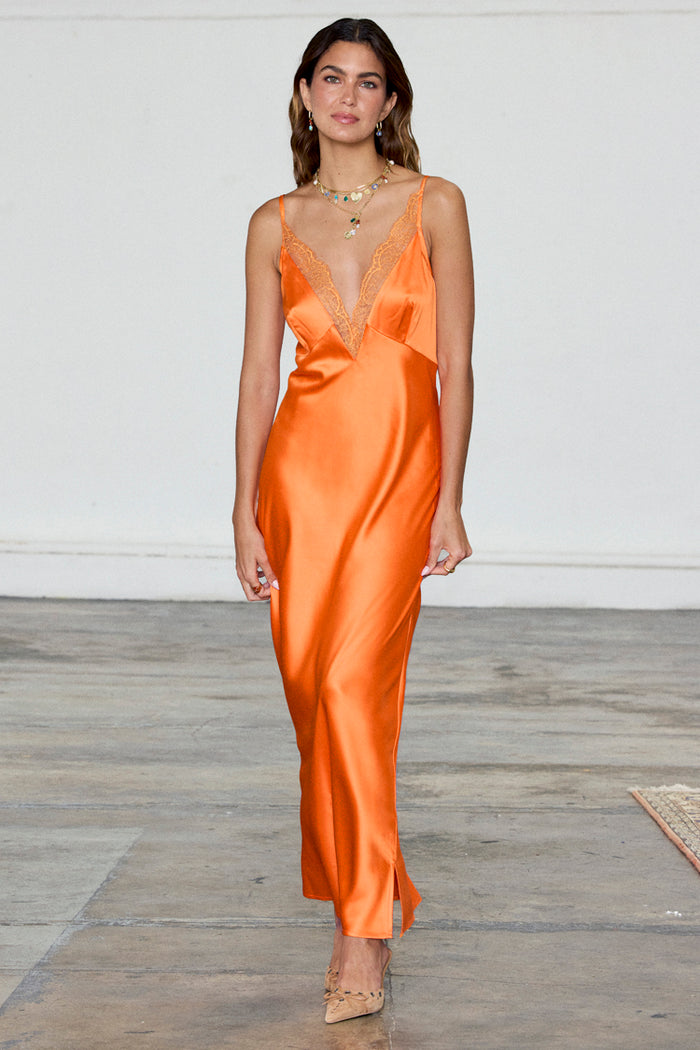 Orange Lily Dress in silky satin featuring a deep V-neckline with sheer lace trim.