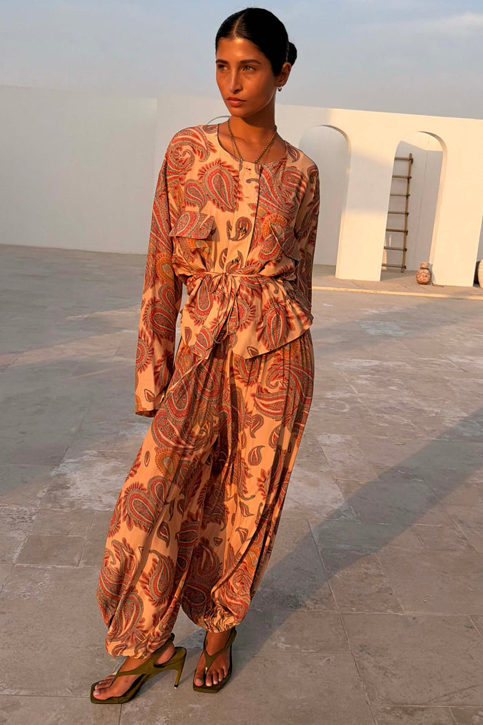Peach Paisley Anna Top with a tie waist and matching balloon trousers for a coordinated vacation look.