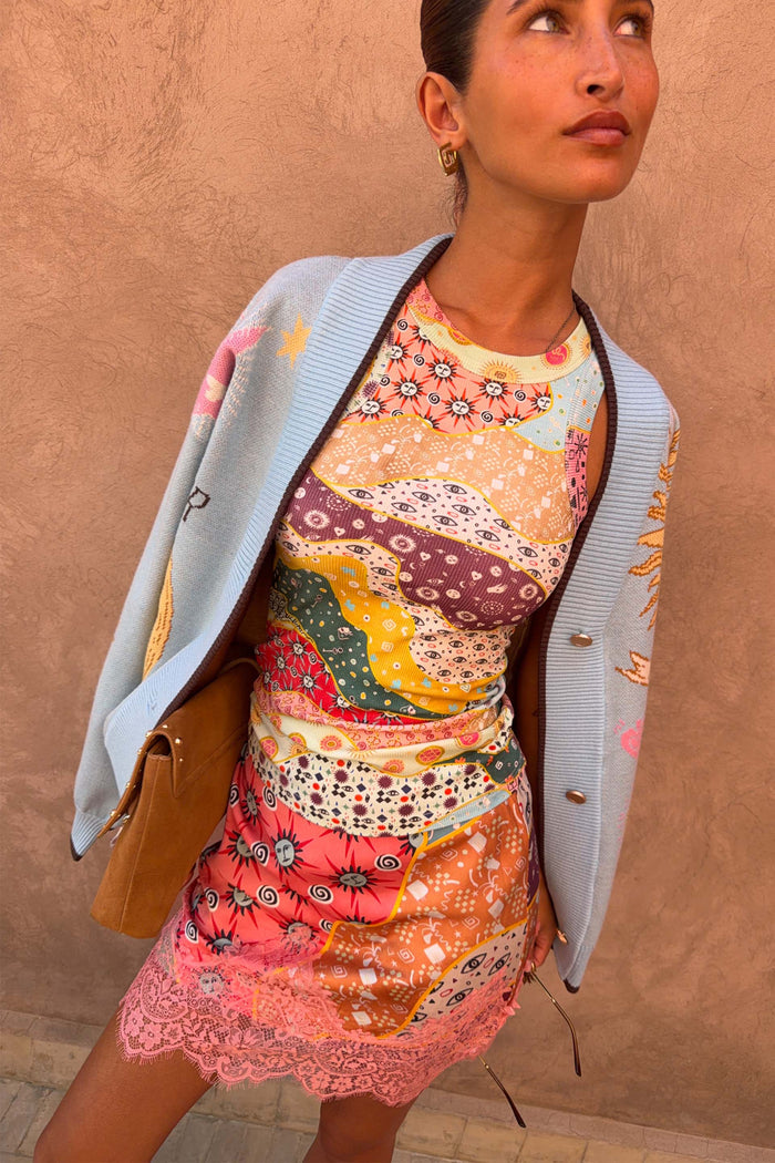 Pastel Morocco Rib Tank Top featuring palm and eye motifs, layered with a light blue cardigan and pink lace trim skirt.