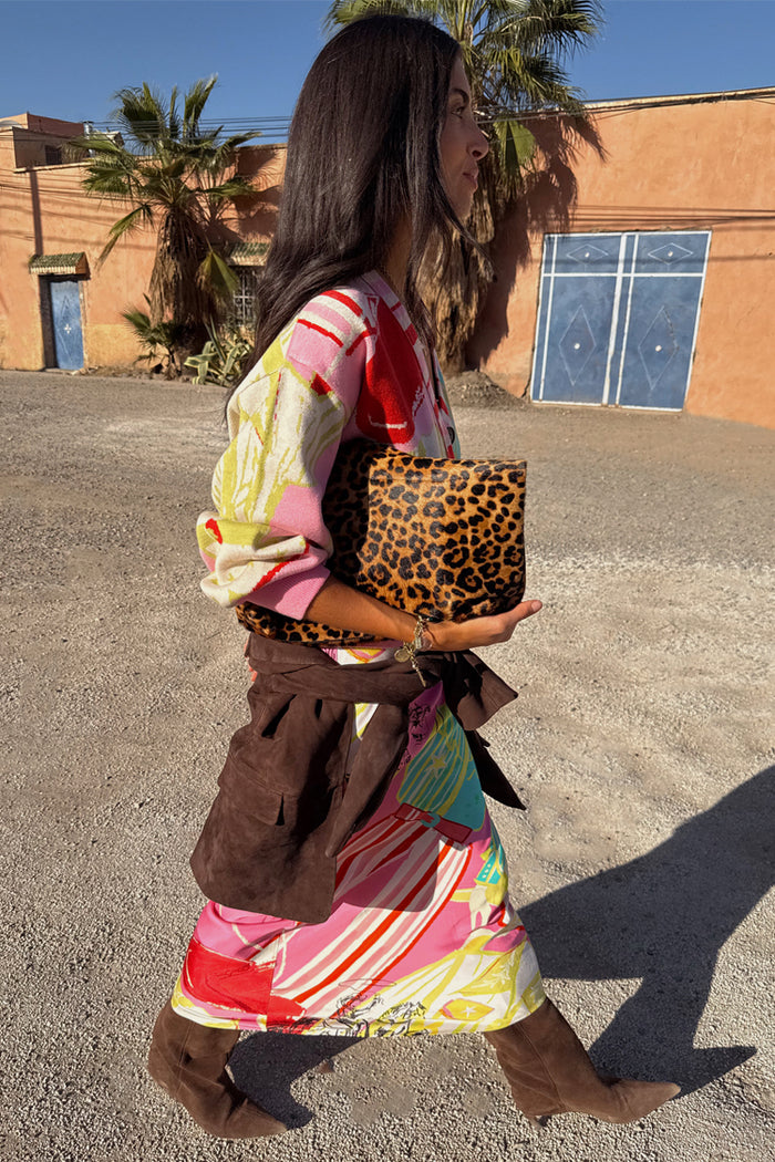 Pink Dallas Dorris Skirt featuring an in-house abstract cowboy print, styled with a leopard clutch and brown suede boots.