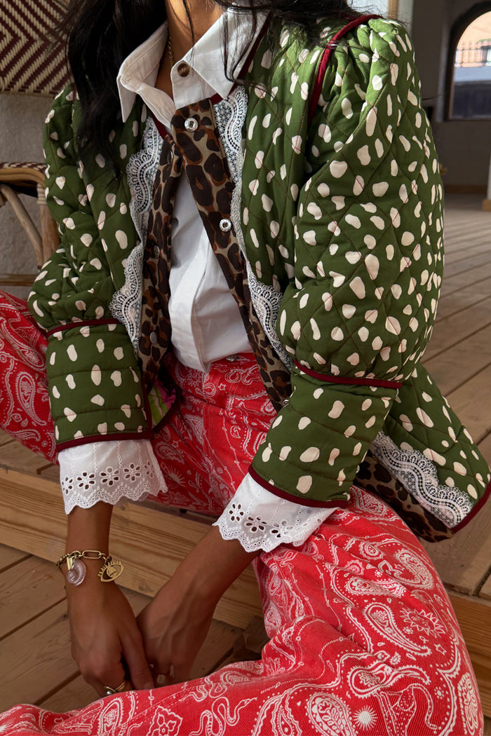 Green Dallas Reversible Jacket in a quilted deer print with leopard trim and white lace cuffs.