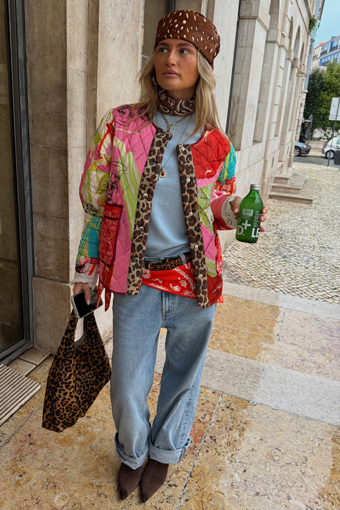 Pink Dallas Reversible Quilted Jacket with cowgirl motifs and leopard trim, styled with baggy jeans for a street look.